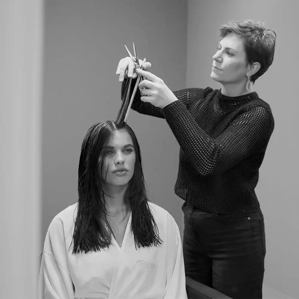A hairdresser combing a client's hair