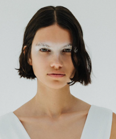 young woman with dark hair and a choppy bob