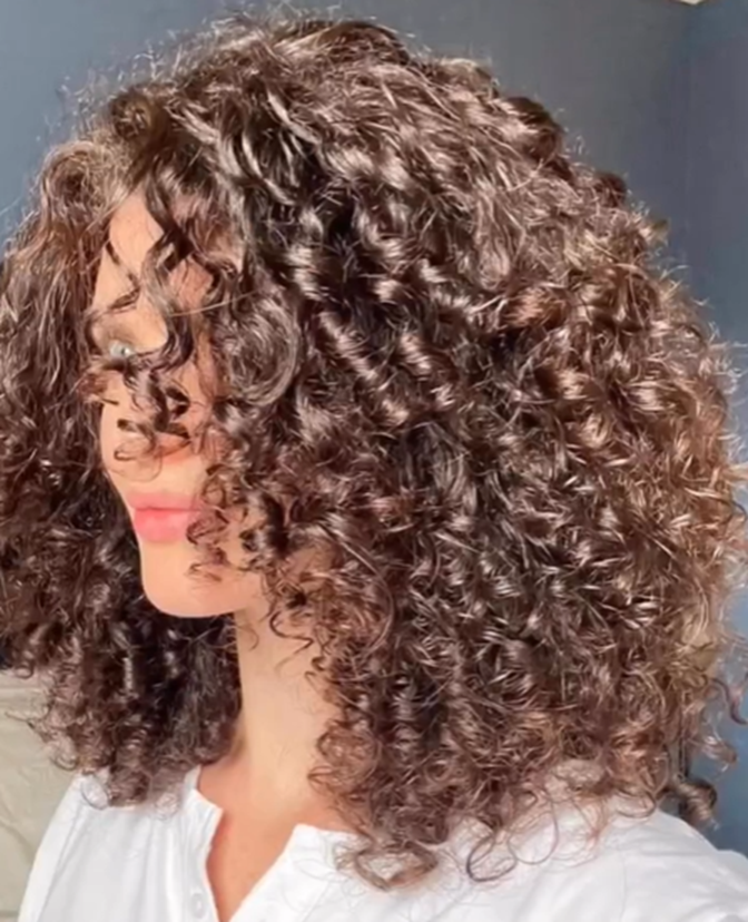 young woman with type 3 curls and a long bob