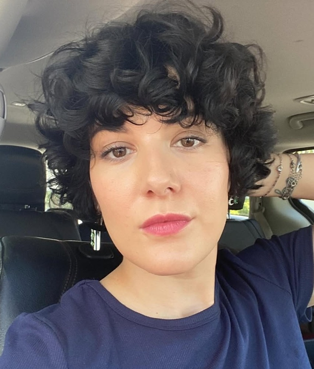 Woman with short curly dark hair